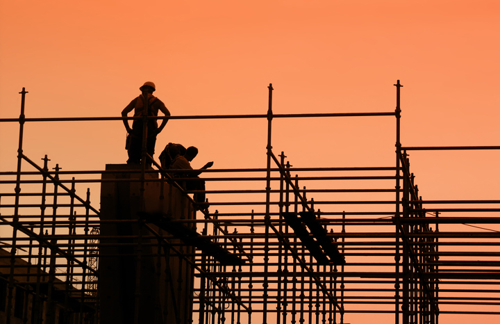 Construction workers on scaffolding.